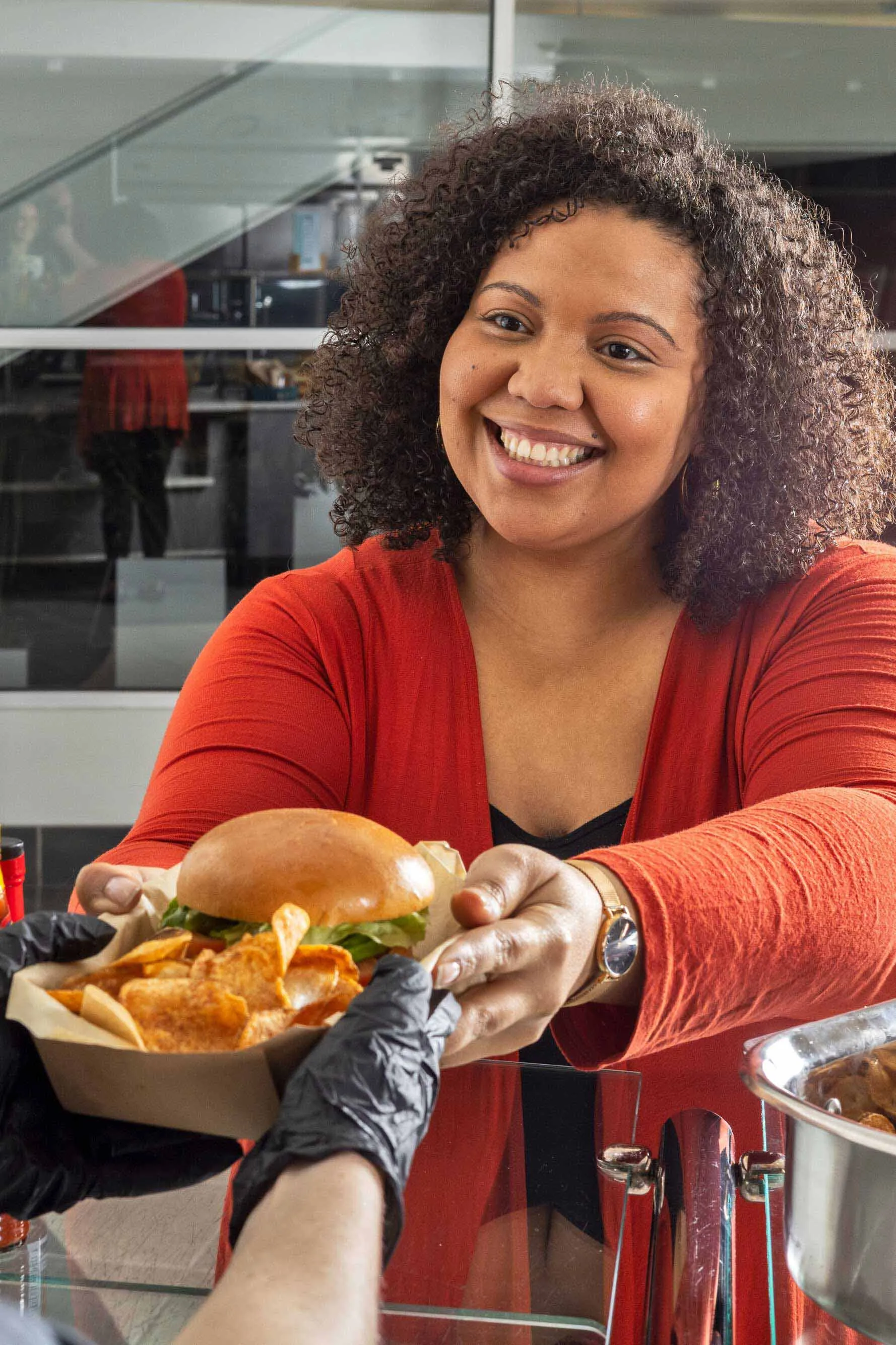 Customer reaching for food with a smile